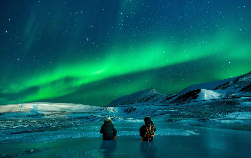 Couple watching Northern Lights in Norway