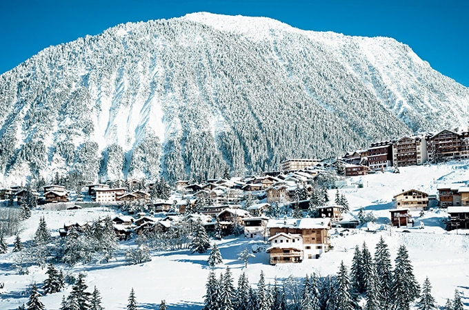 Snowy mountains with a small town in the French Alps