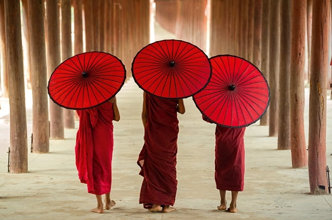 The photogenic U Bein Bridge and Buddhist monks in their distinctive saffron-red robes in Myanmar