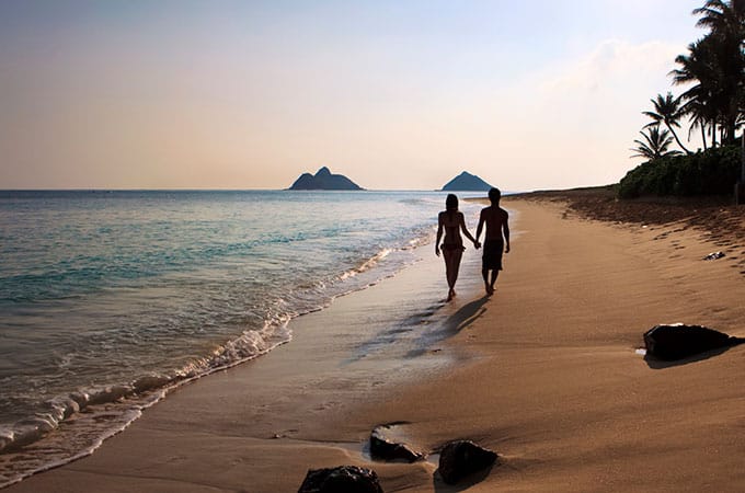 Couple walking on beach Hawaii