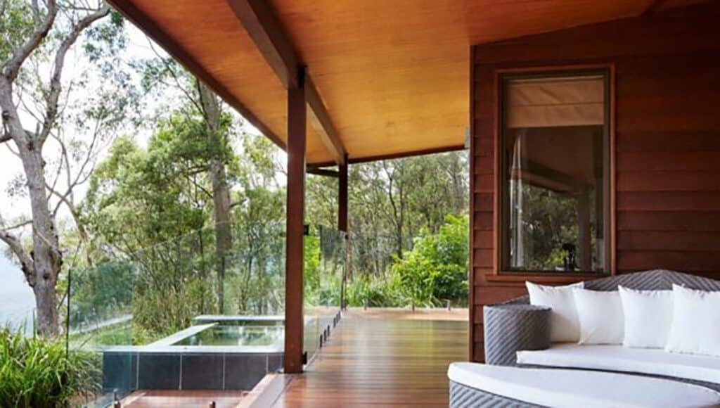 outdoor terrace with dipping pool and lounging area and sofa at Spicers Peak Lodge in Queensland