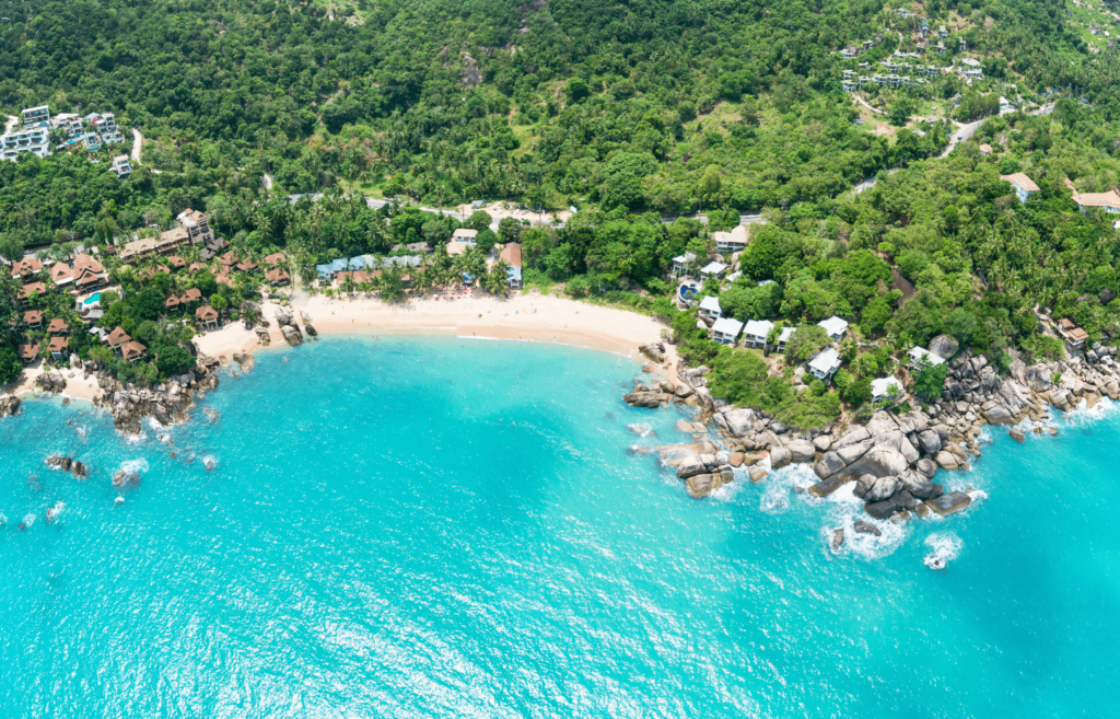 Aerial view of Koh Samui with its resorts and beautiful white sand beaches and clear waters during daytime