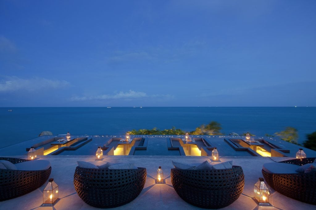 Silavadee-Pool-Spa-Resort-Koh-Samui-Thailand-Oceanfront-pool-with-seats-and-view-of-the-ocean-during-nighttime