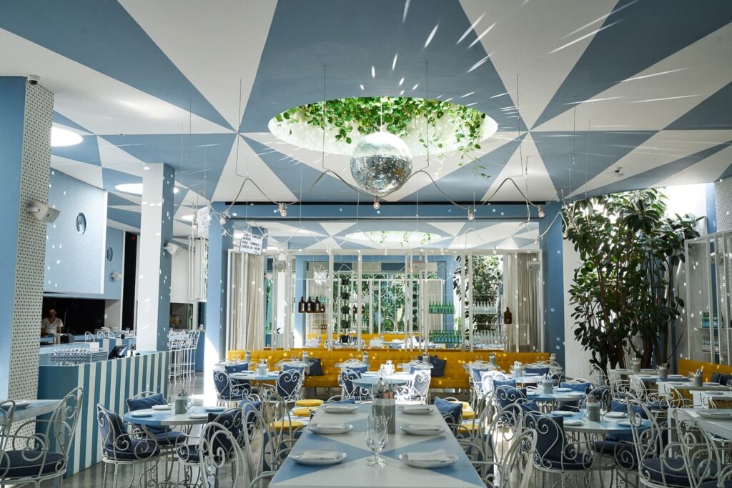 Da-Maria-Seminyak-restaurant-dining-area-with-a-view-of-the-kitchen-seats-and-tables-disco-light