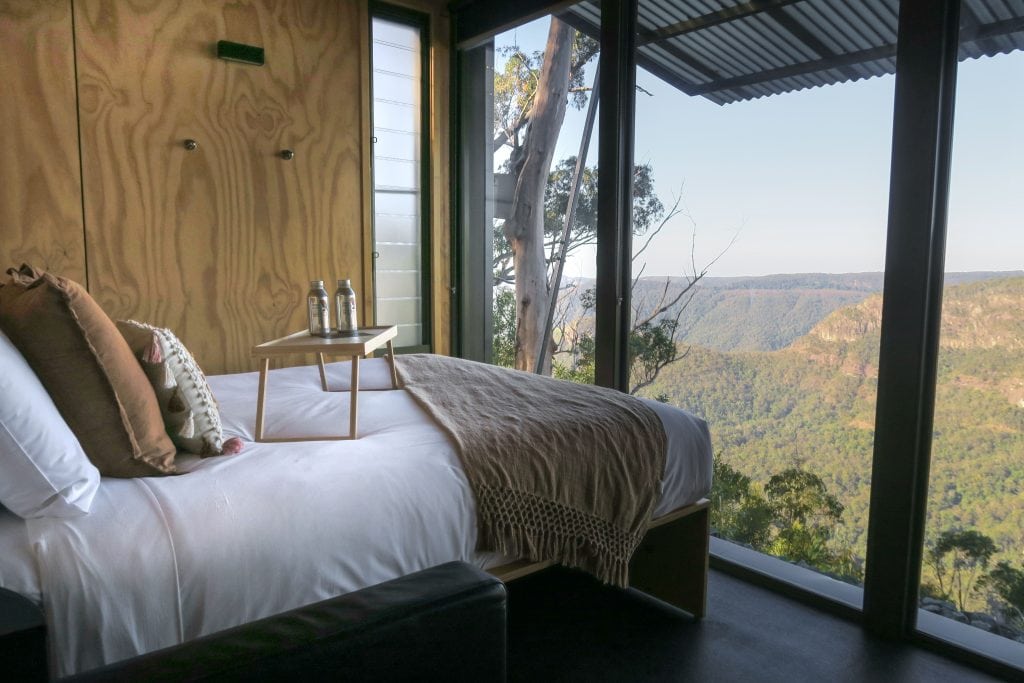 Binna-Burra-Famil-Tiny-wild-houses-Gold-coast-Hinterland-bedroom-with-bed-and-floor-to-ceiling-or-picture-windows-with-panoramic-views-of-the-surrounding-mountains