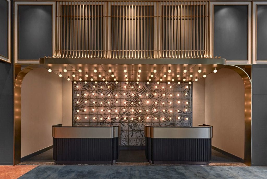 Orchard lobby counter and unique light fixtures at the Vibe Hotel in Singapore