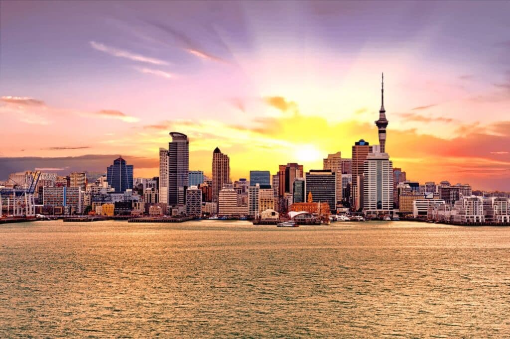 View of the cityscapes of Auckland New Zealand from across the sea during sunset