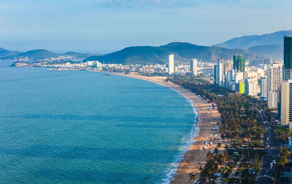 Stretch of beach in Nha Trang with views of the cityscapes in Vietnam