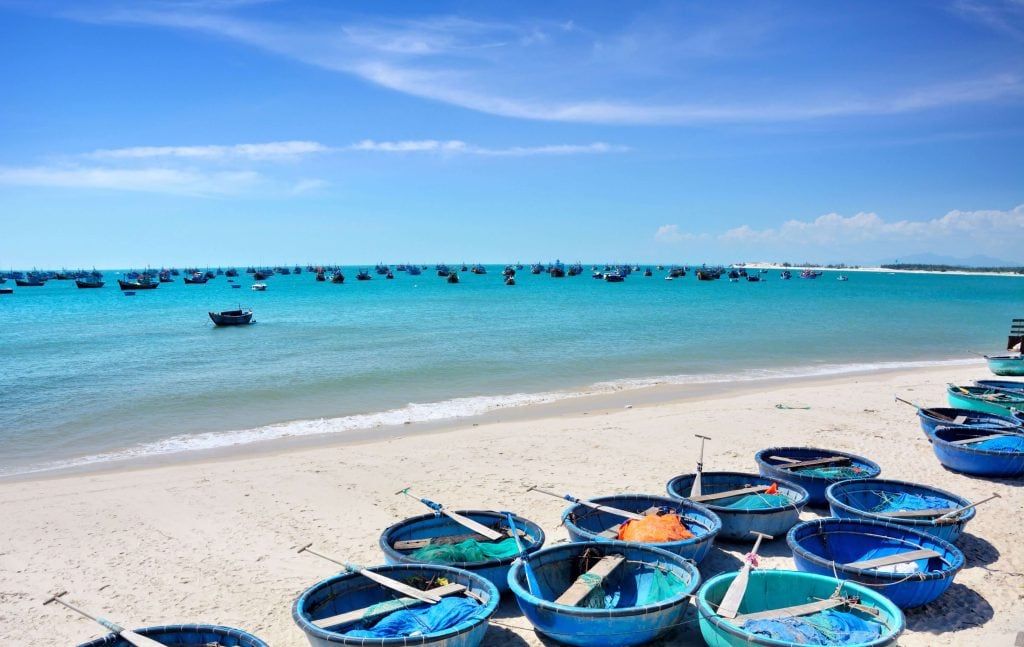 Small basket paddle boats on a beach shore in Vietnam
