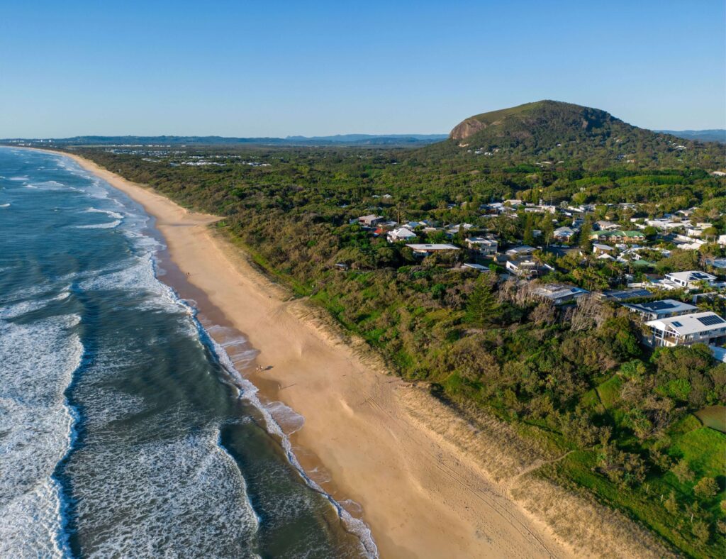 View along Yaroomba Beach with Mt Coolum in background.