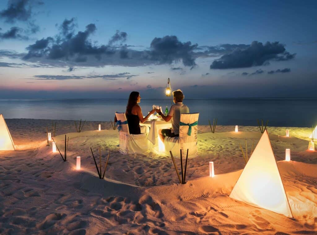 Honeymoon couple dining on beach