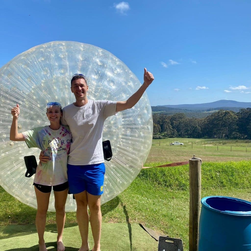 Denmark-Thrills-Adventure-Park-Western-Australia-couple-with-a-human-hamster-ball-or-zorb-ball-in-the-background