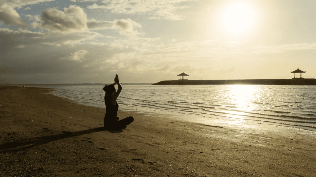 Young Woman Exercising Yoga on the Sanur Beach
